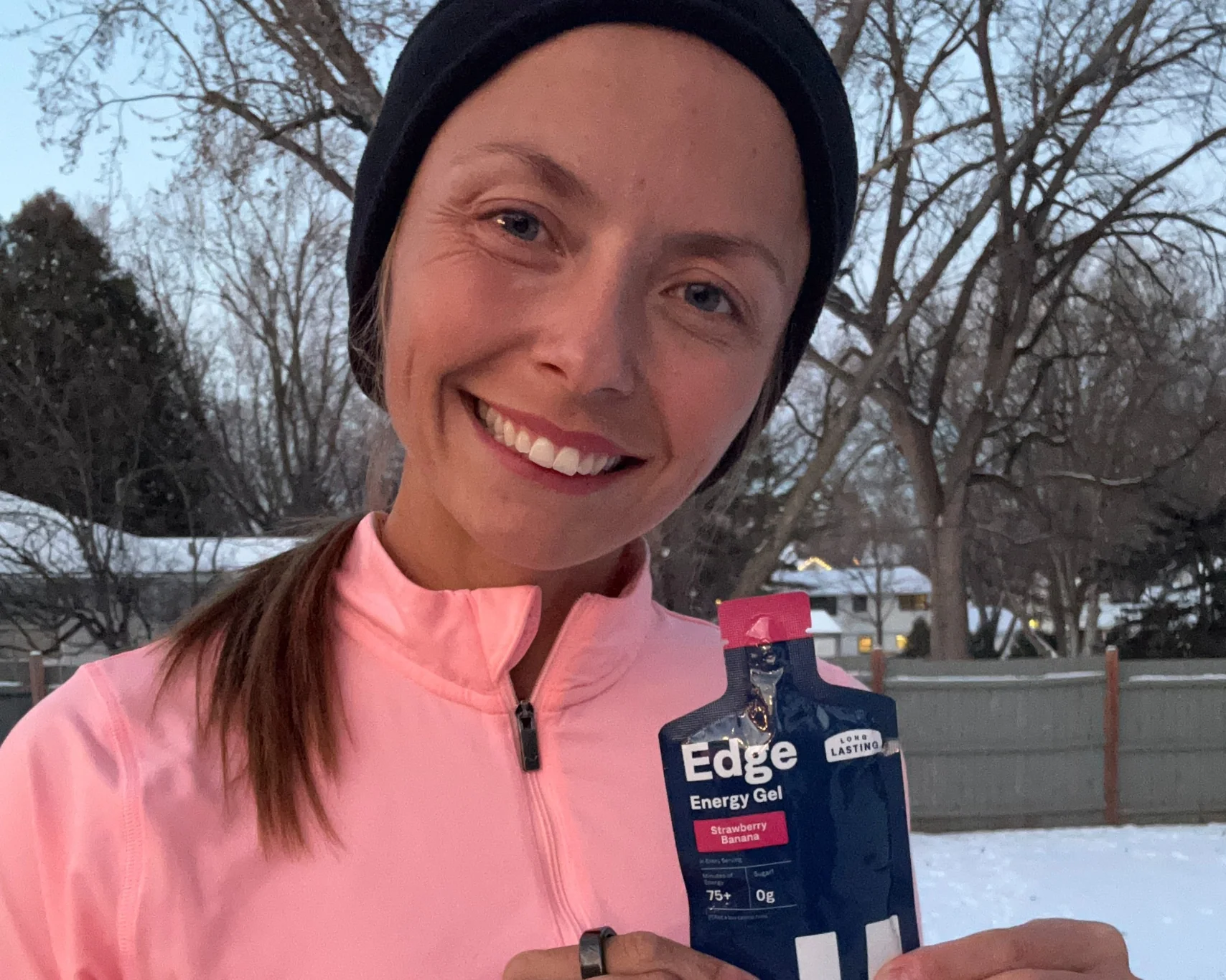 Dakotah Popehn, U.S. Olympic marathon runner, holding a Strawberry Banana UCAN EDGE gel